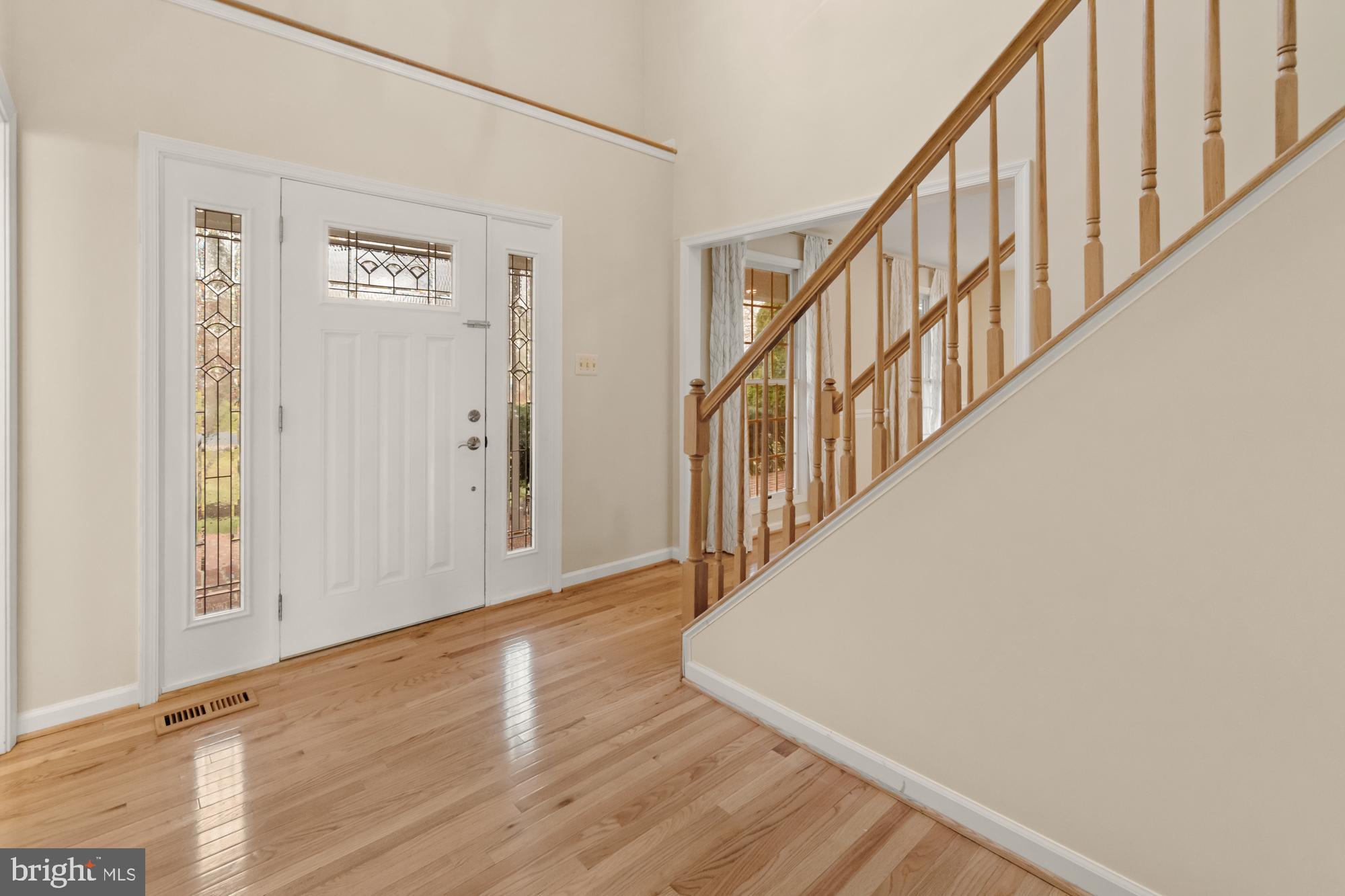 16908 Hoskinson Road Poolesville, MD 20837 - Photo 22 of 72 a view of a hallway with wooden floor and staircase