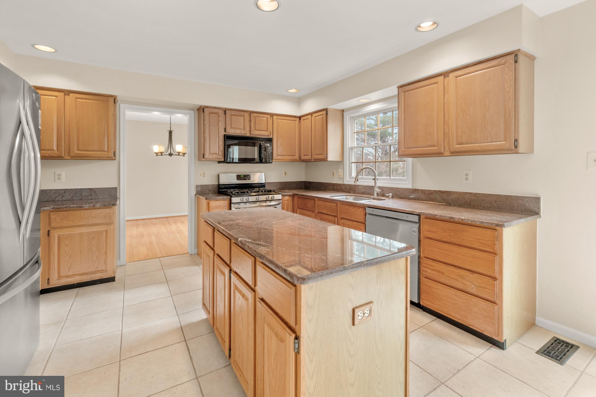 16908 Hoskinson Road Poolesville, MD 20837 - Photo 27 of 72 a kitchen with stainless steel appliances granite countertop a sink stove and cabinets