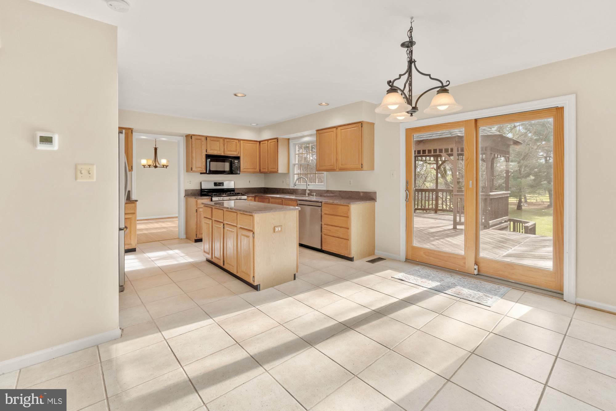 16908 Hoskinson Road Poolesville, MD 20837 - Photo 29 of 72 a large kitchen with stainless steel appliances granite countertop a stove top oven a sink a counter space and cabinets