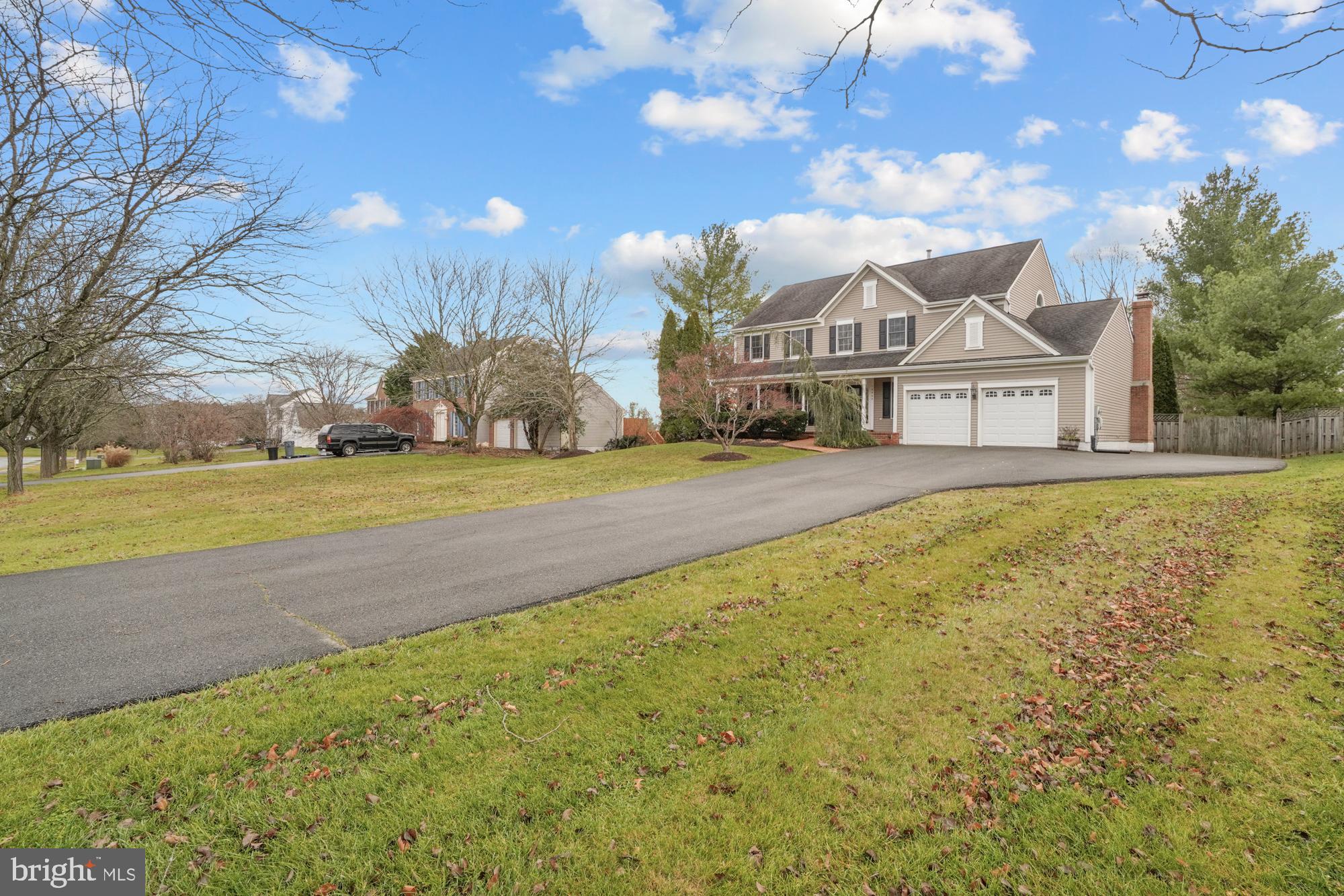16908 Hoskinson Road Poolesville, MD 20837 - Photo 3 of 72 a front view of a house with a big yard and large trees