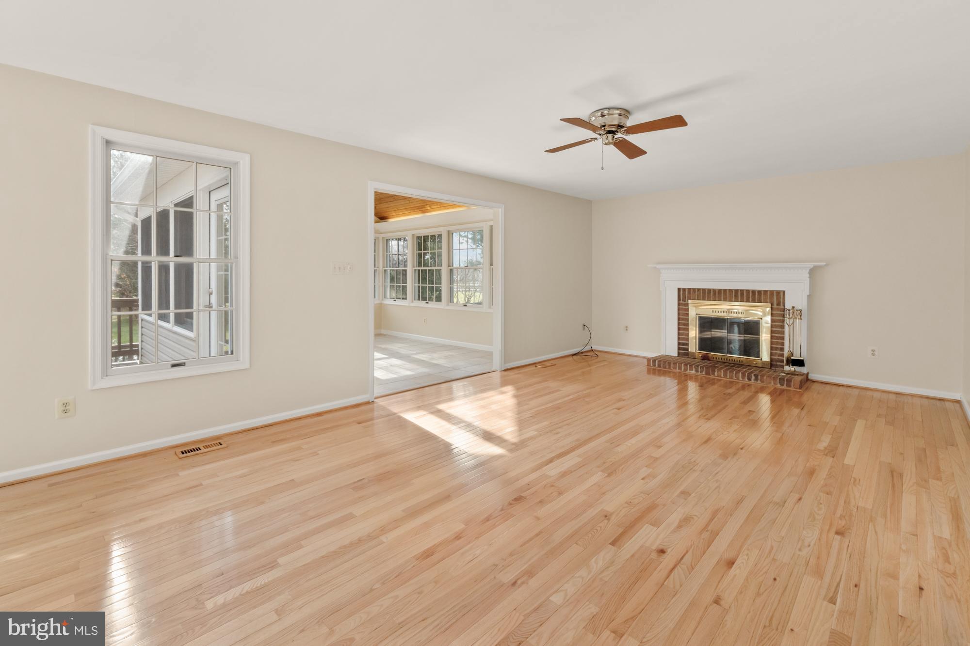16908 Hoskinson Road Poolesville, MD 20837 - Photo 31 of 72 a view of empty room with wooden floor and fan