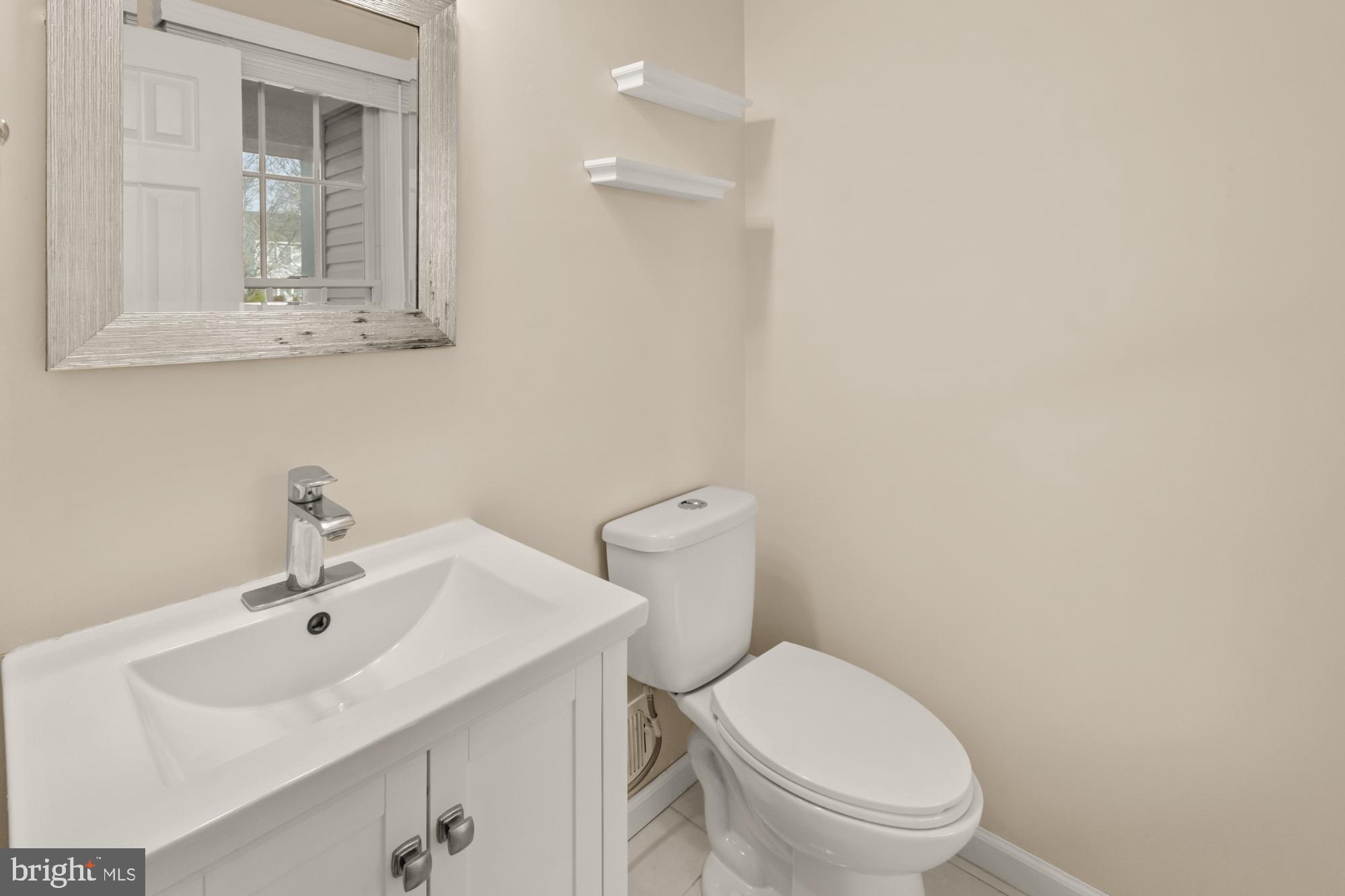 16908 Hoskinson Road Poolesville, MD 20837 - Photo 38 of 72 a bathroom with a sink a toilet and mirror