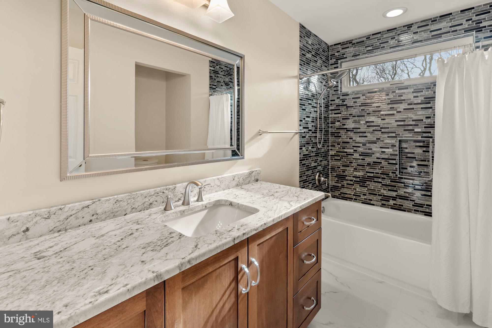 16908 Hoskinson Road Poolesville, MD 20837 - Photo 48 of 72 a bathroom with a granite countertop sink and a mirror
