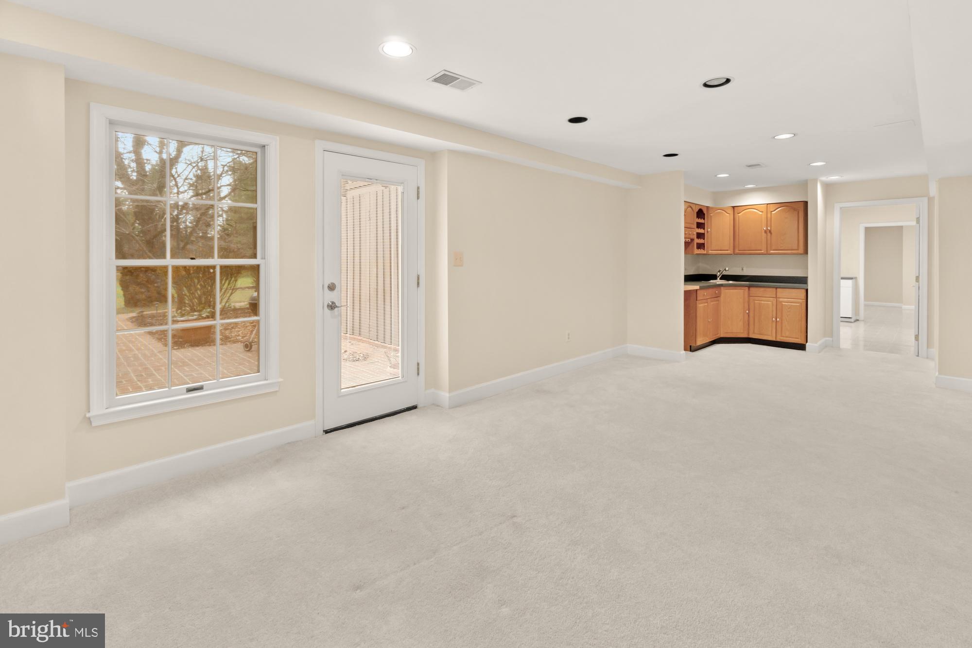 16908 Hoskinson Road Poolesville, MD 20837 - Photo 50 of 72 an empty room with windows and cabinet