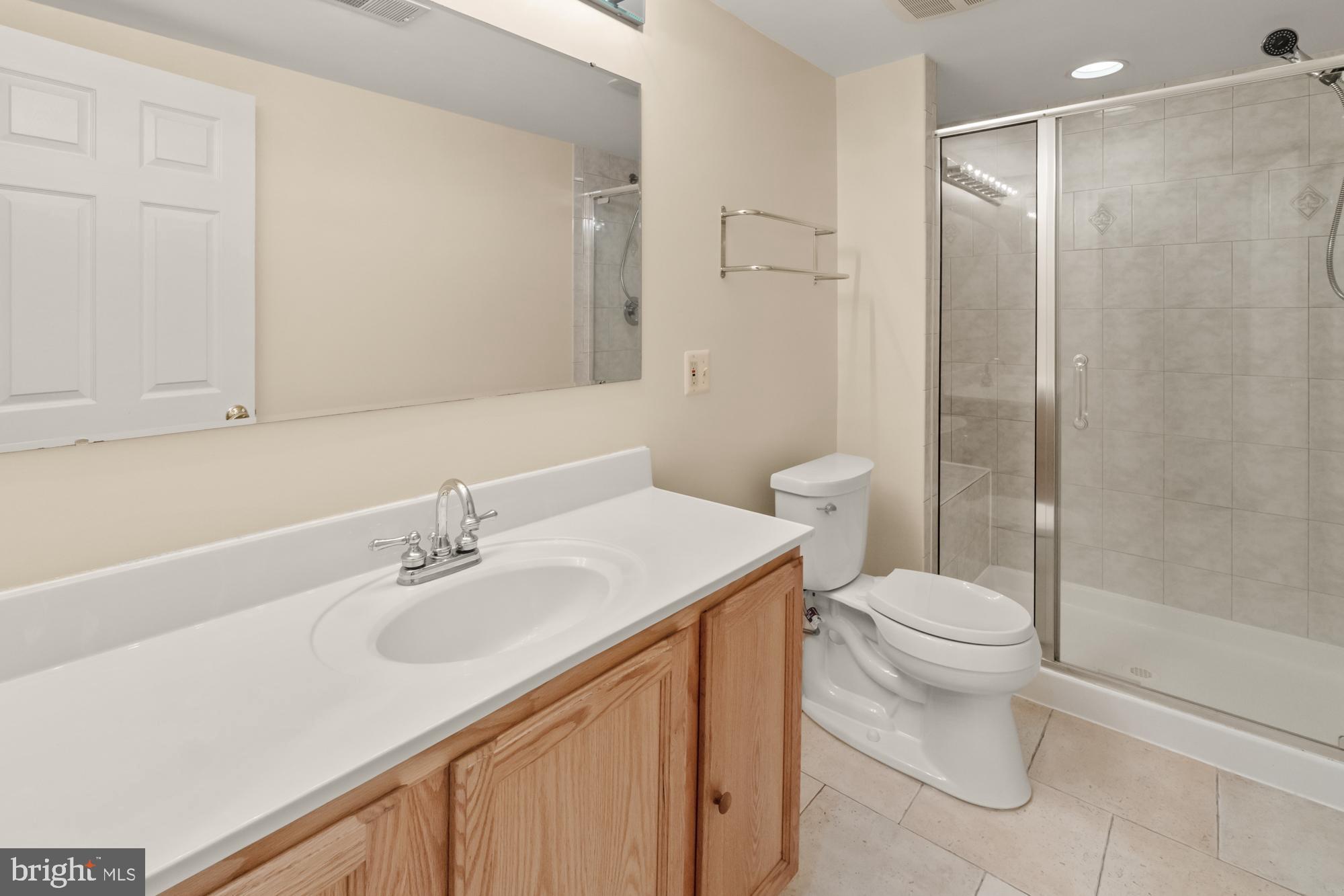 16908 Hoskinson Road Poolesville, MD 20837 - Photo 52 of 72 a bathroom with a sink toilet and shower