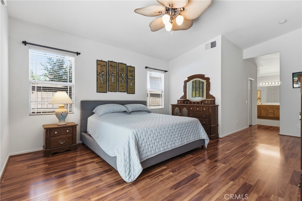 33145 Vermont Road Temecula, CA 92592 - Photo 21 of 41 a bedroom with a large bed and a chandelier