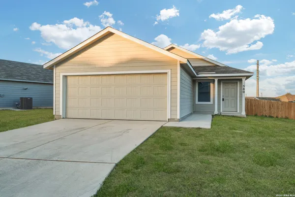 a view of backyard of house and garage