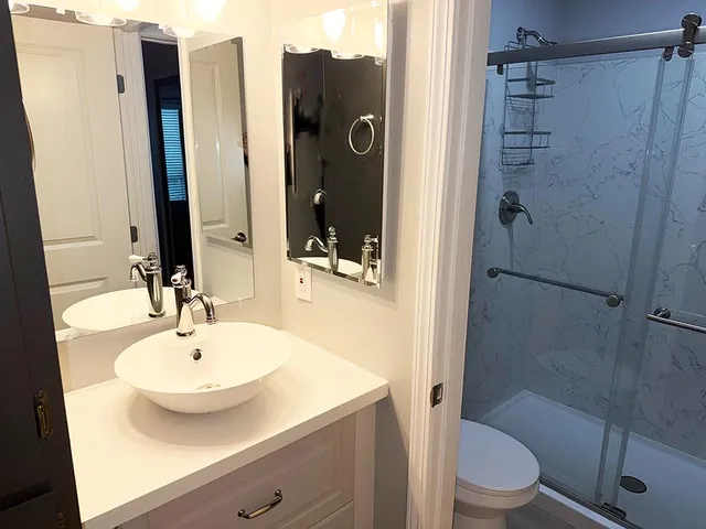 a view of a hallway with wooden floor and stairs