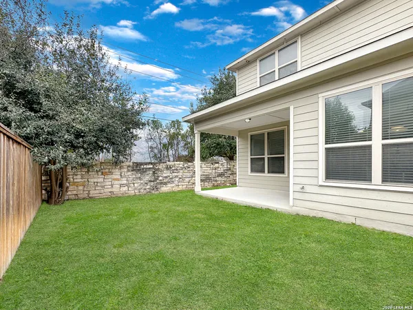 a view of a house with a yard and sitting area