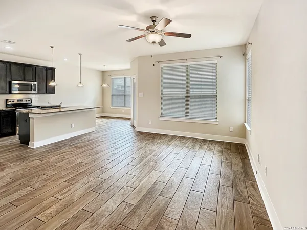 a view of kitchen with granite countertop cabinets and wooden floor