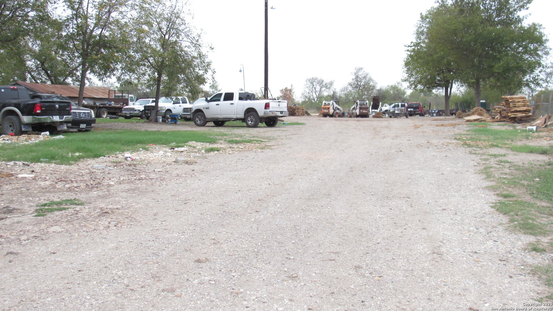 9221 Nelson Road San Antonio, TX 78252 - Photo 11 of 22 a view of a road with a car parked in the background