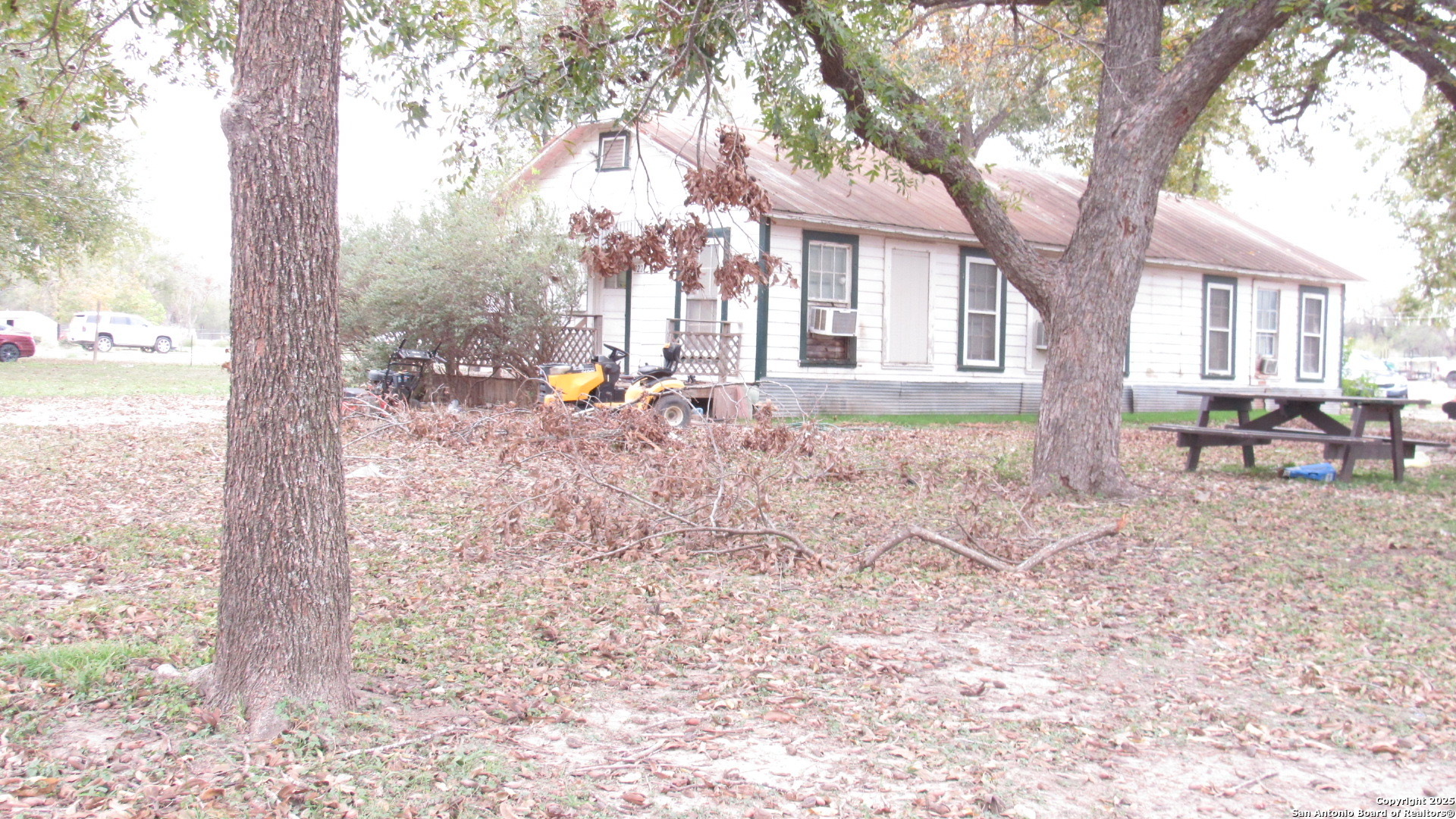 9221 Nelson Road San Antonio, TX 78252 - Photo 2 of 22 a backyard of a house with table and chairs