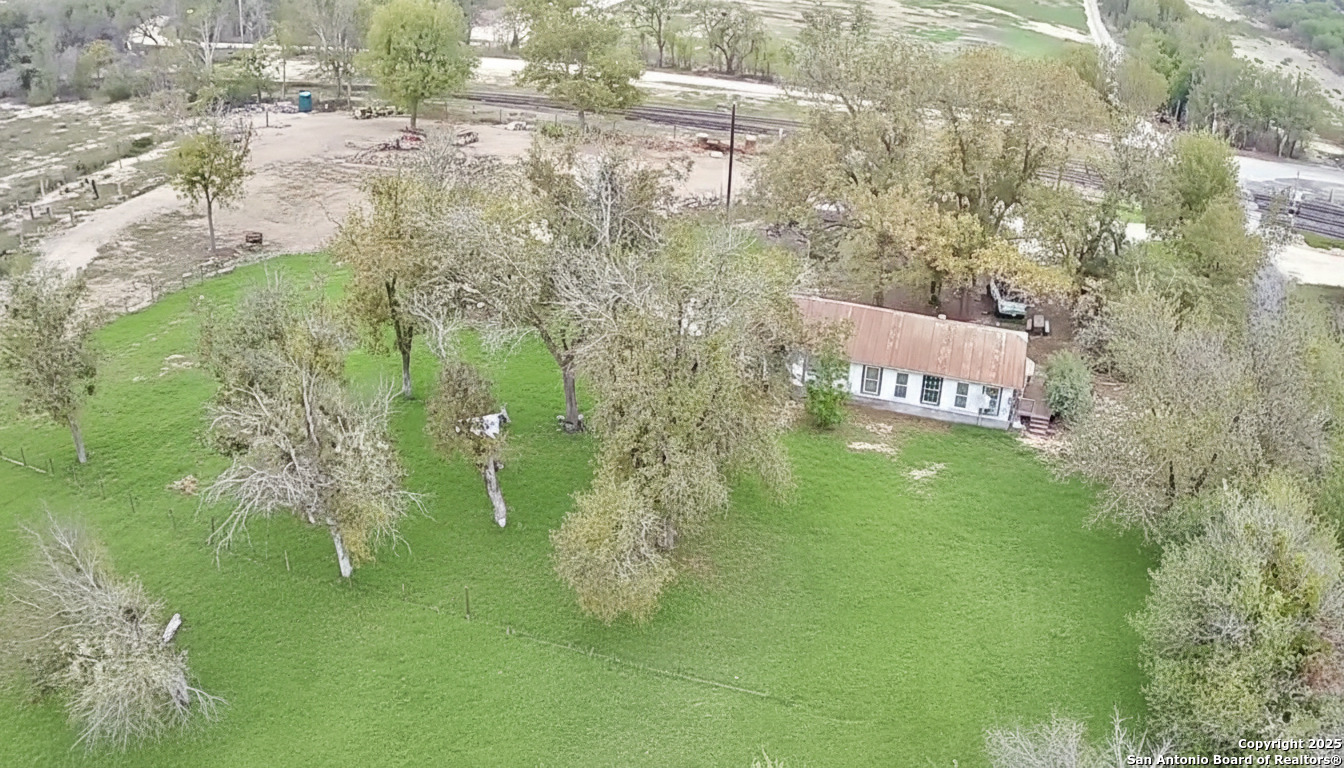 9221 Nelson Road San Antonio, TX 78252 - Photo 22 of 22 a sign that is sitting in the grass next to a building