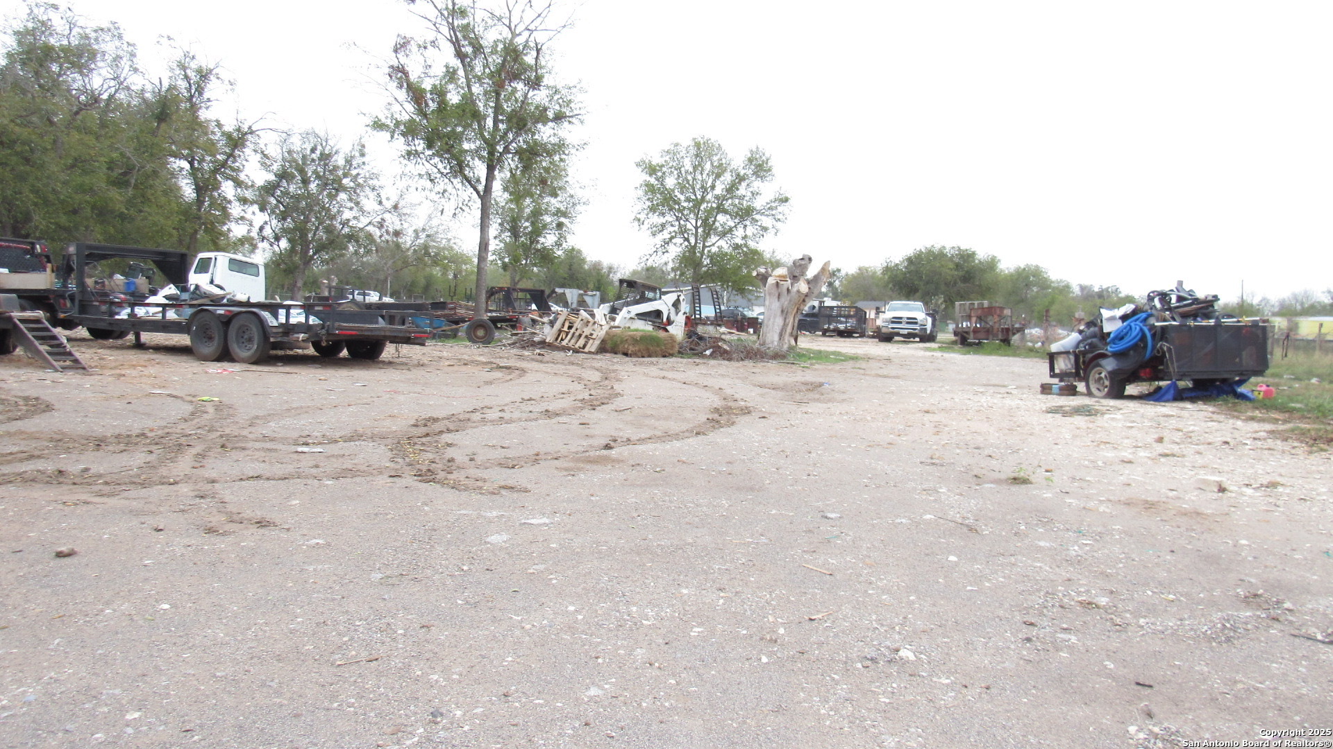 9221 Nelson Road San Antonio, TX 78252 - Photo 9 of 22 a view of a dirt road with a building