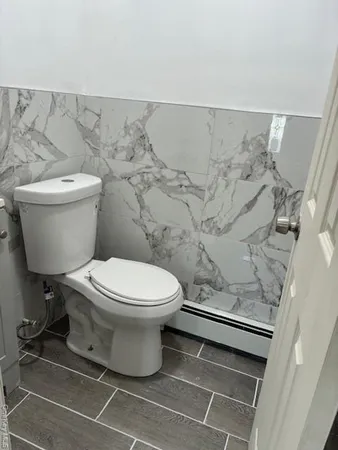 a white toilet sitting next to a bathroom sink