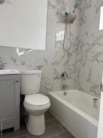 a bathroom with a toilet a sink and bathtub