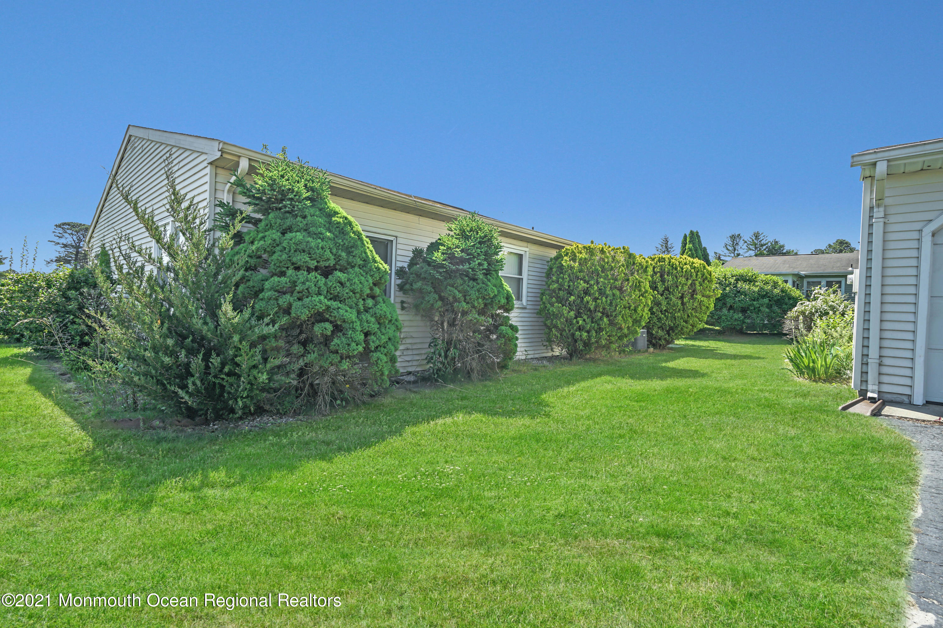 44 Churchill Road, Unit 71 Whiting, NJ 08759 - Photo 1 of 17 a view of a garden with a building in the background