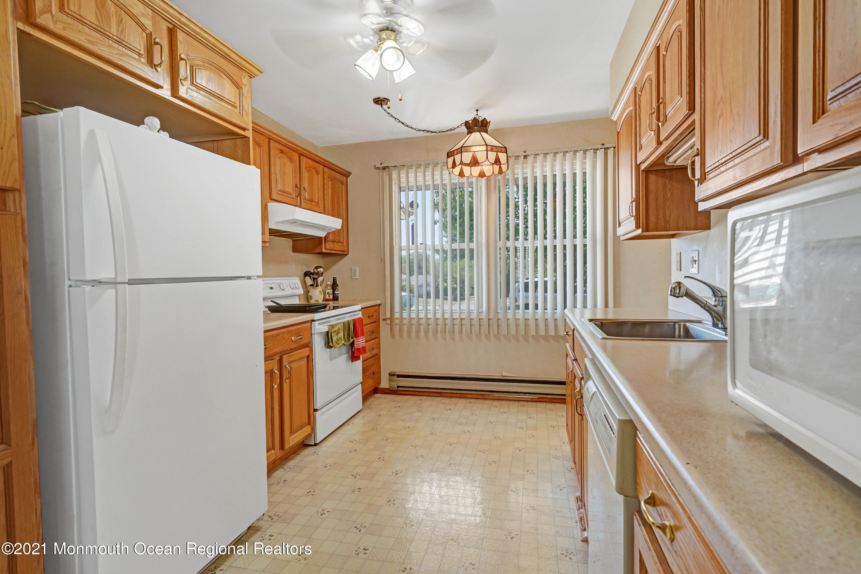 44 Churchill Road, Unit 71 Whiting, NJ 08759 - Photo 11 of 17 a kitchen with a refrigerator and a sink