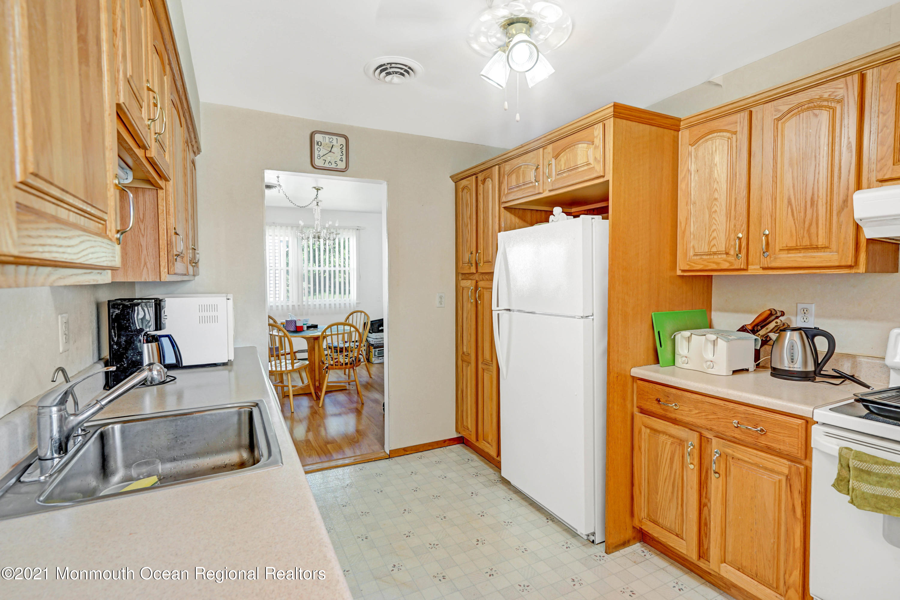 44 Churchill Road, Unit 71 Whiting, NJ 08759 - Photo 12 of 17 a kitchen with stainless steel appliances granite countertop a refrigerator and a sink