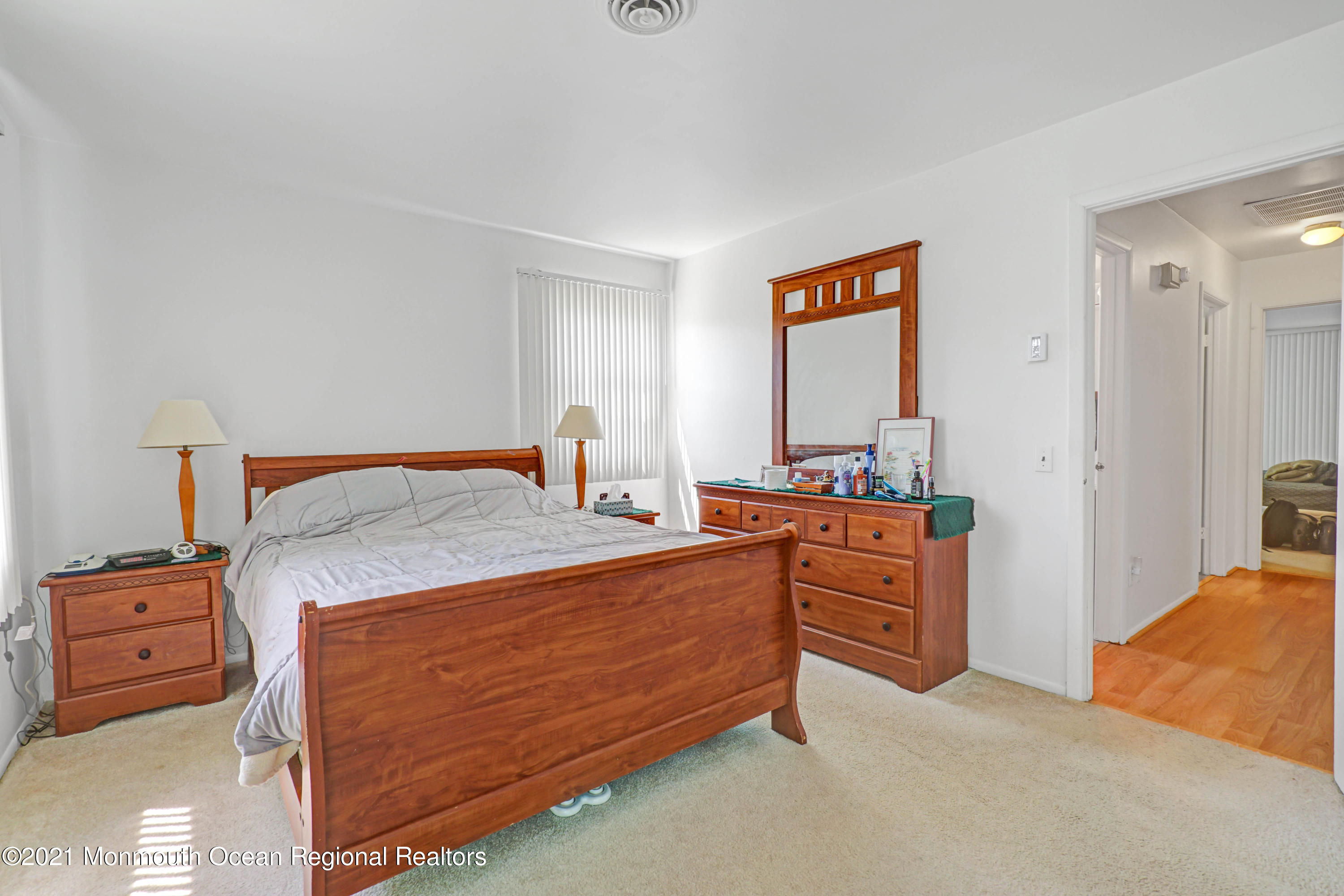 44 Churchill Road, Unit 71 Whiting, NJ 08759 - Photo 17 of 17 a bed room with a bed and a dresser