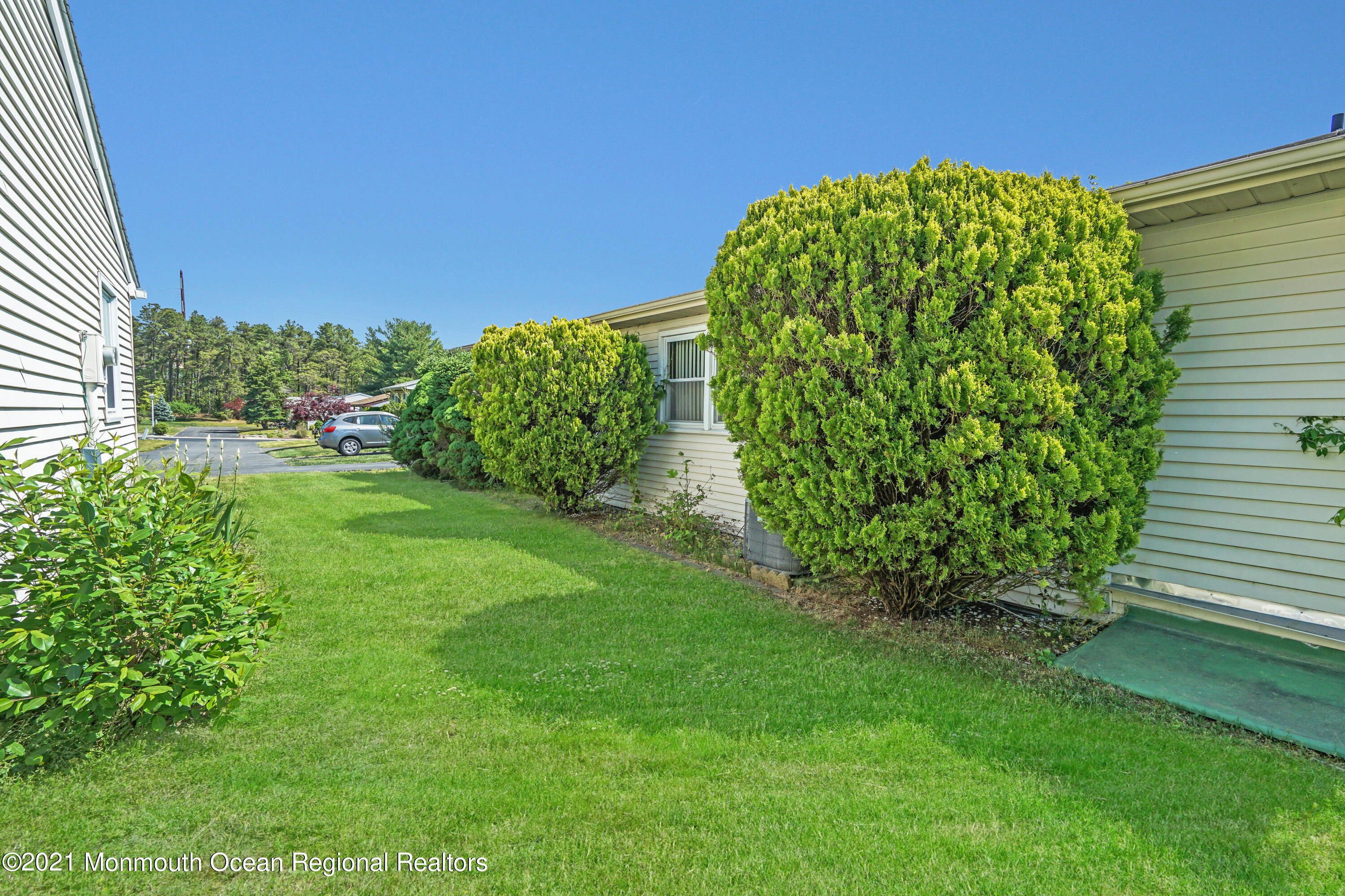 44 Churchill Road, Unit 71 Whiting, NJ 08759 - Photo 2 of 17 a view of a garden with a plant
