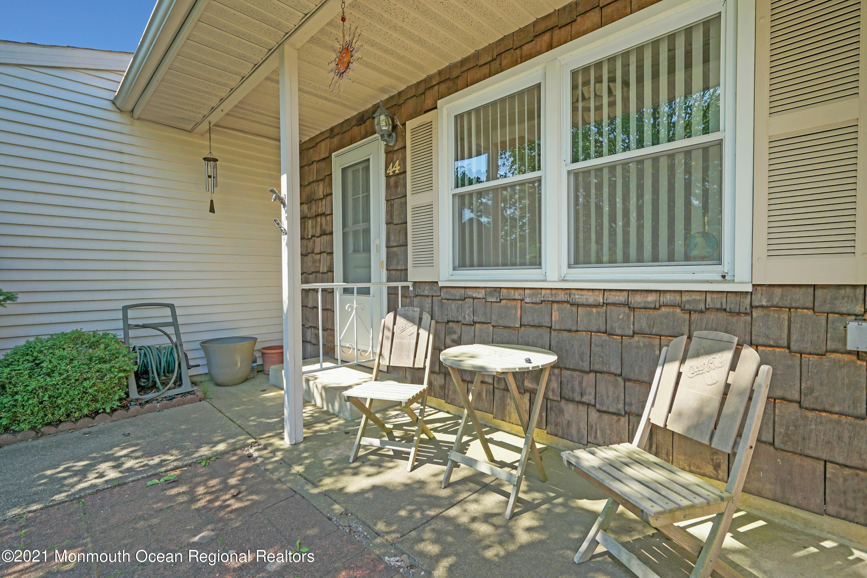 44 Churchill Road, Unit 71 Whiting, NJ 08759 - Photo 7 of 17 a couple of chairs sitting in front of a house
