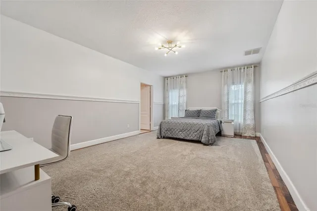 a room with a bed and a chandelier