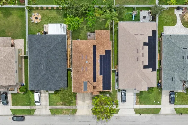 an aerial view of a house with a yard