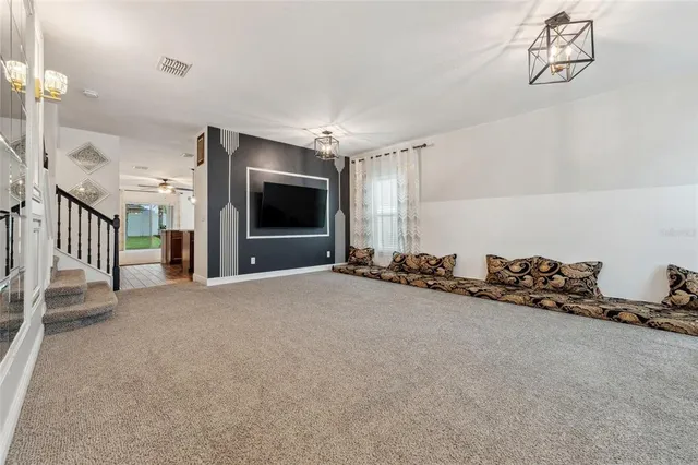 a view of a livingroom with furniture and a flat screen tv