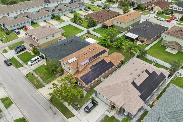an aerial view of residential houses with outdoor space