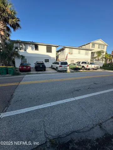 a view of a white house with a sink and yard