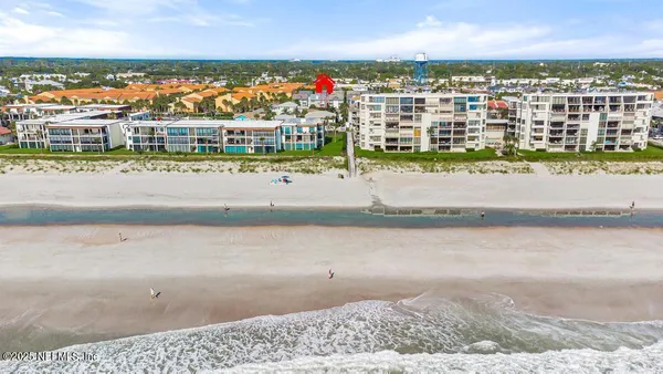 an aerial view of residential houses with city view