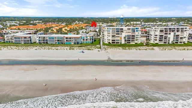 an aerial view of residential houses with city view