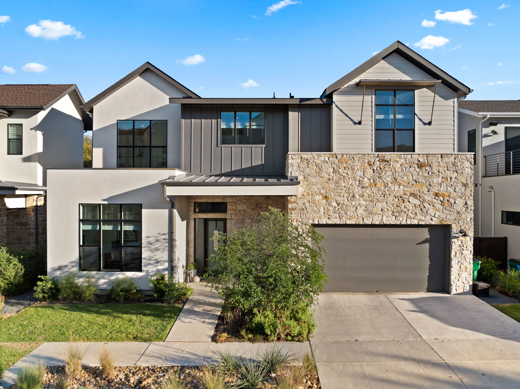 4003 Independent Way, Unit 182 Austin, TX 78731 - Photo 2 of 40 a front view of a house with a yard and garage