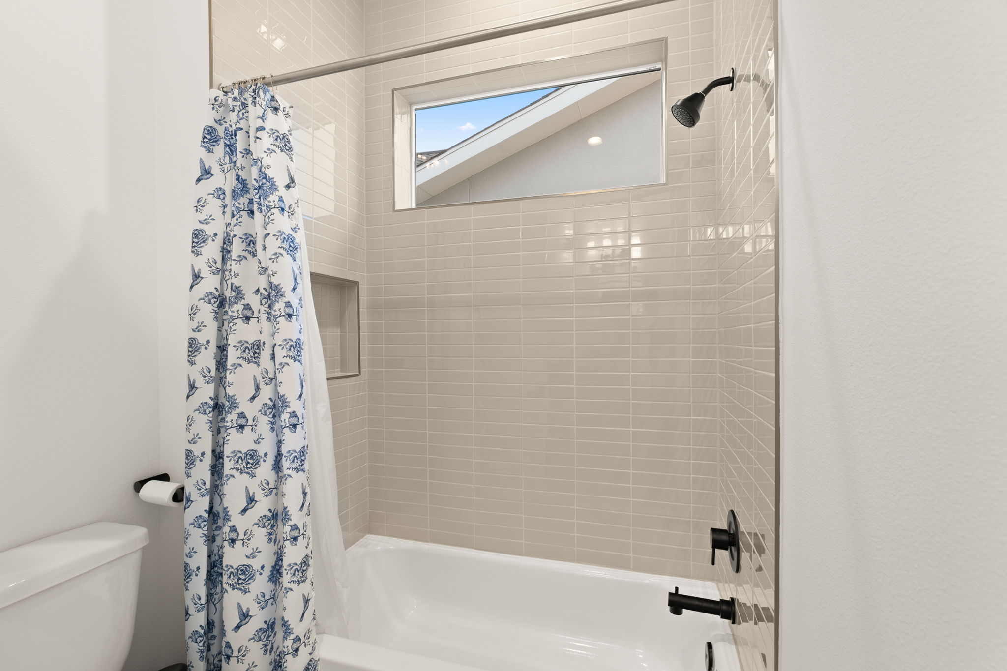 4003 Independent Way, Unit 182 Austin, TX 78731 - Photo 25 of 40 a bathroom with a shower curtain and a toilet