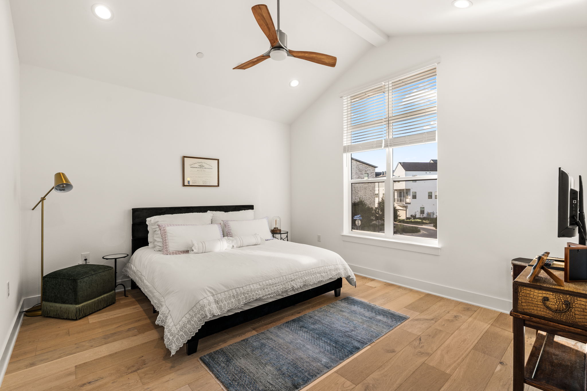 4003 Independent Way, Unit 182 Austin, TX 78731 - Photo 26 of 40 a bedroom with a bed a wall painting and a window