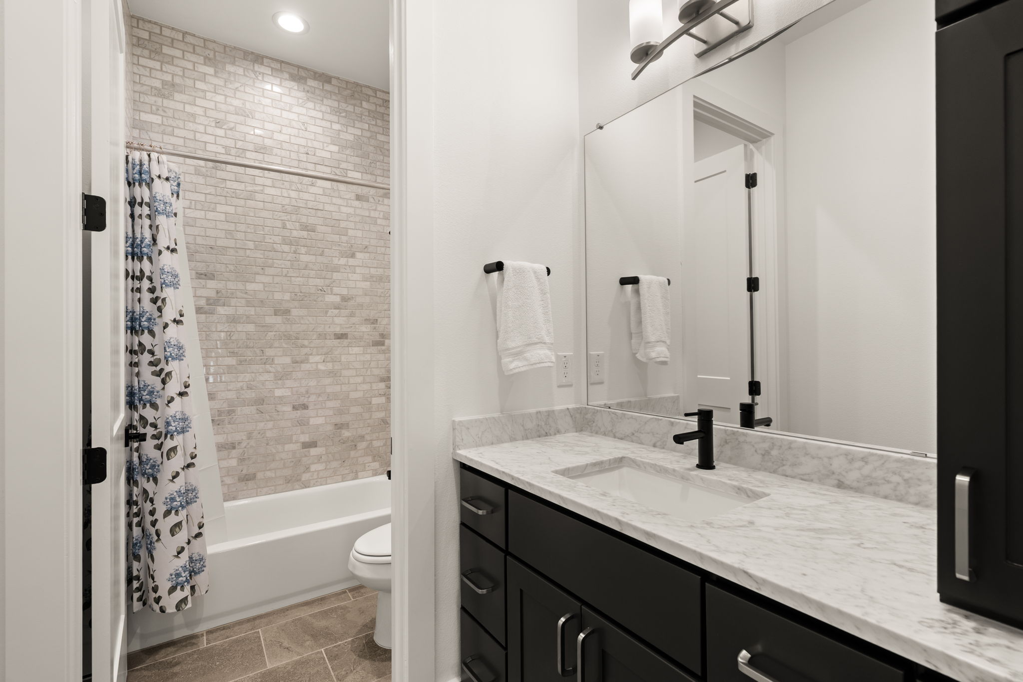 4003 Independent Way, Unit 182 Austin, TX 78731 - Photo 28 of 40 a bathroom with a granite countertop sink toilet a large mirror and shower