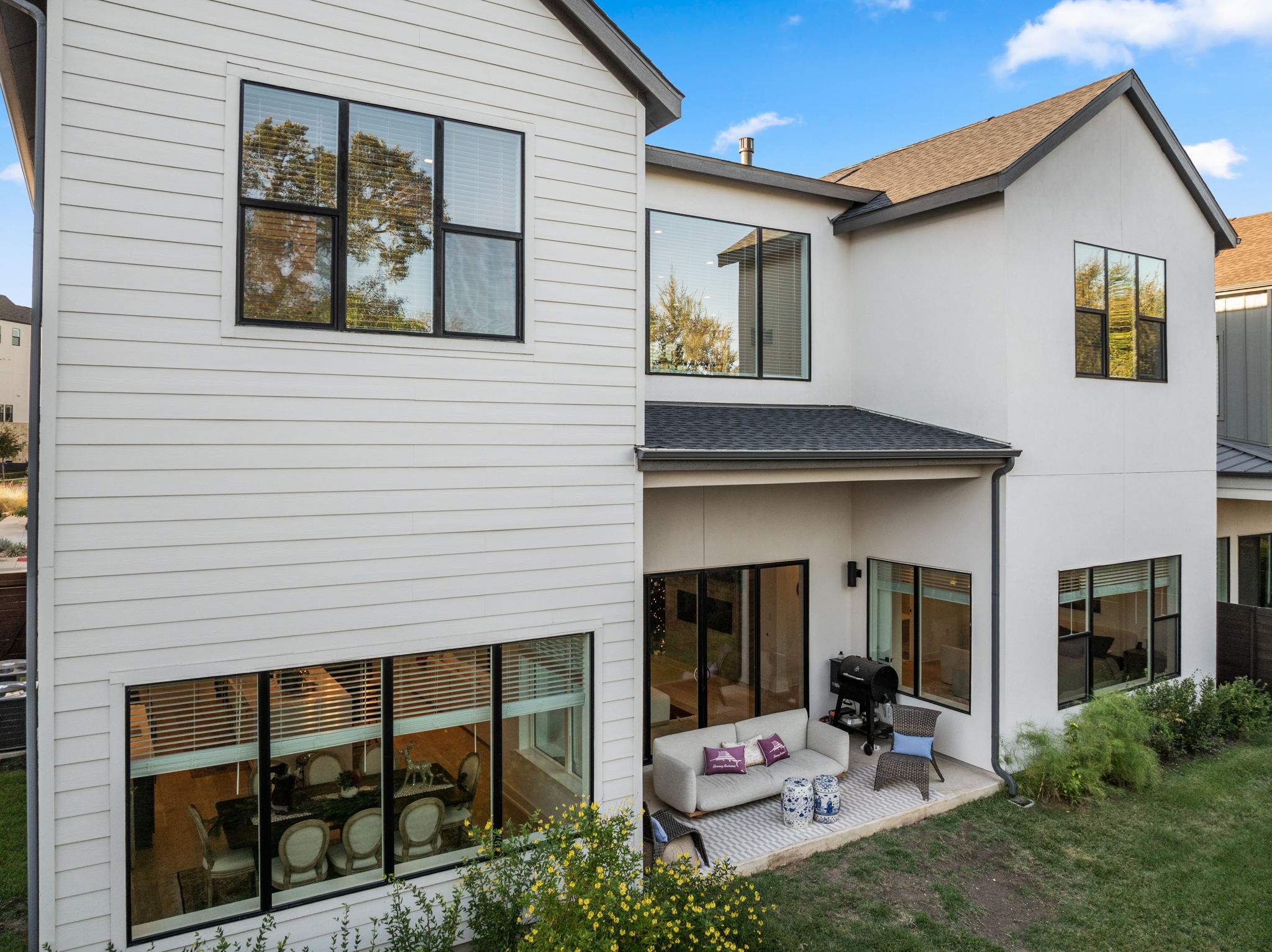 4003 Independent Way, Unit 182 Austin, TX 78731 - Photo 33 of 40 Back of property featuring roof with shingles, an outdoor living space, a patio, and stucco siding