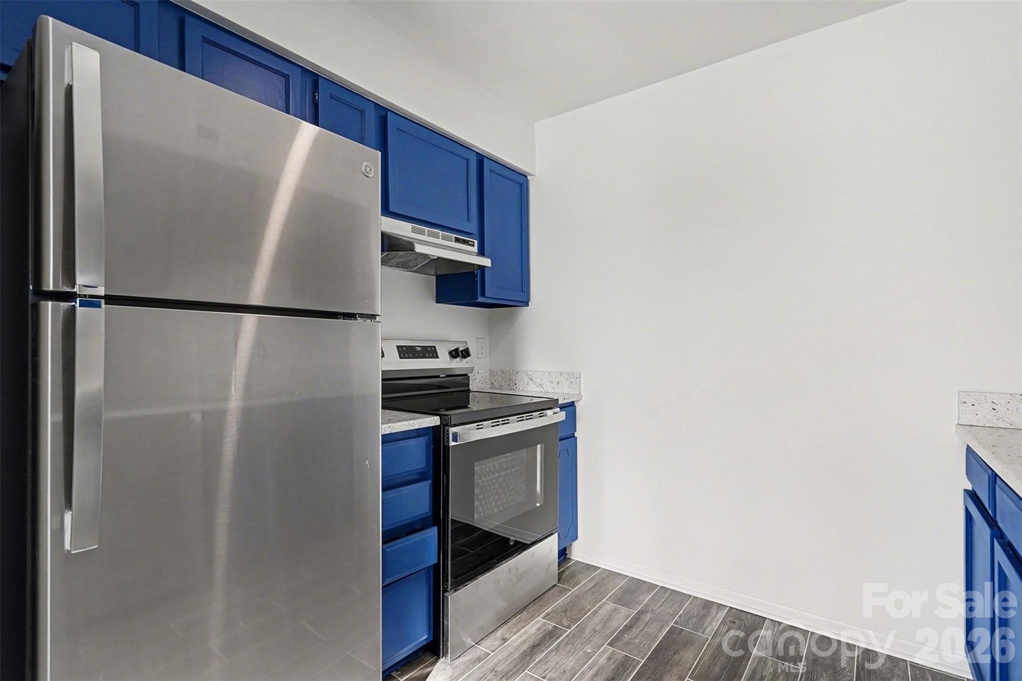 6148 Heath Ridge Court Charlotte, NC 28210 - Photo 16 of 27 a white refrigerator freezer and a stove sitting inside of a kitchen
