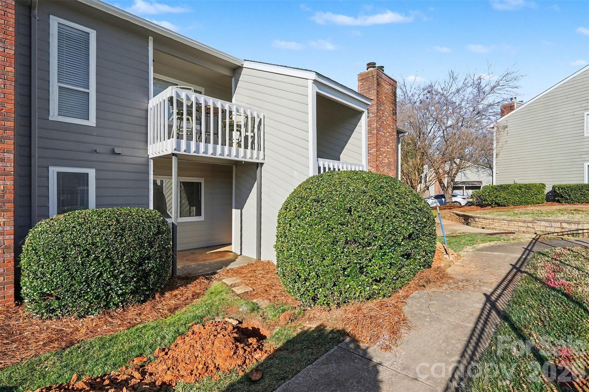 6148 Heath Ridge Court Charlotte, NC 28210 - Photo 2 of 27 a front view of a house with garden