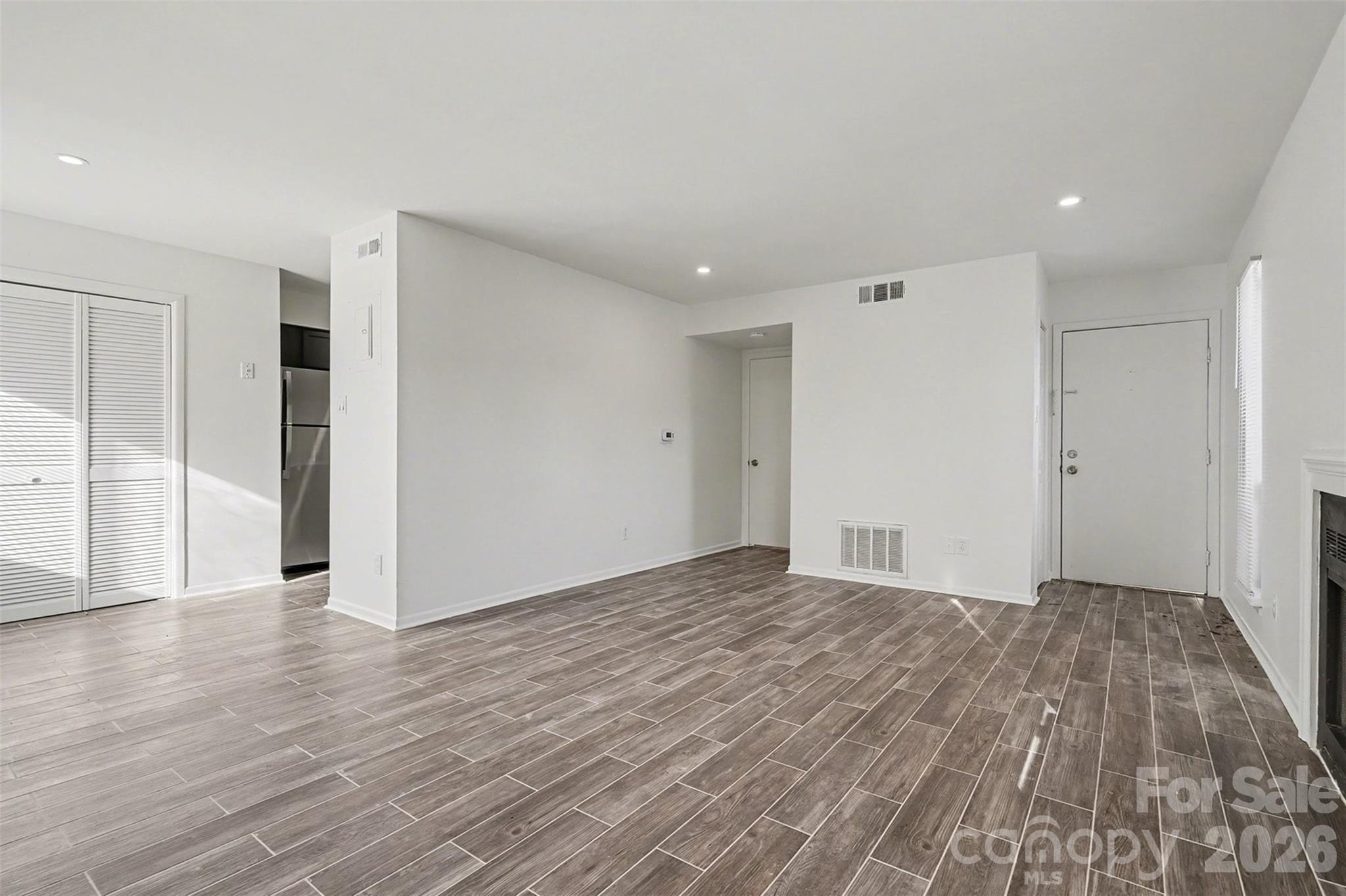 6148 Heath Ridge Court Charlotte, NC 28210 - Photo 9 of 27 a view of an empty room with wooden floor