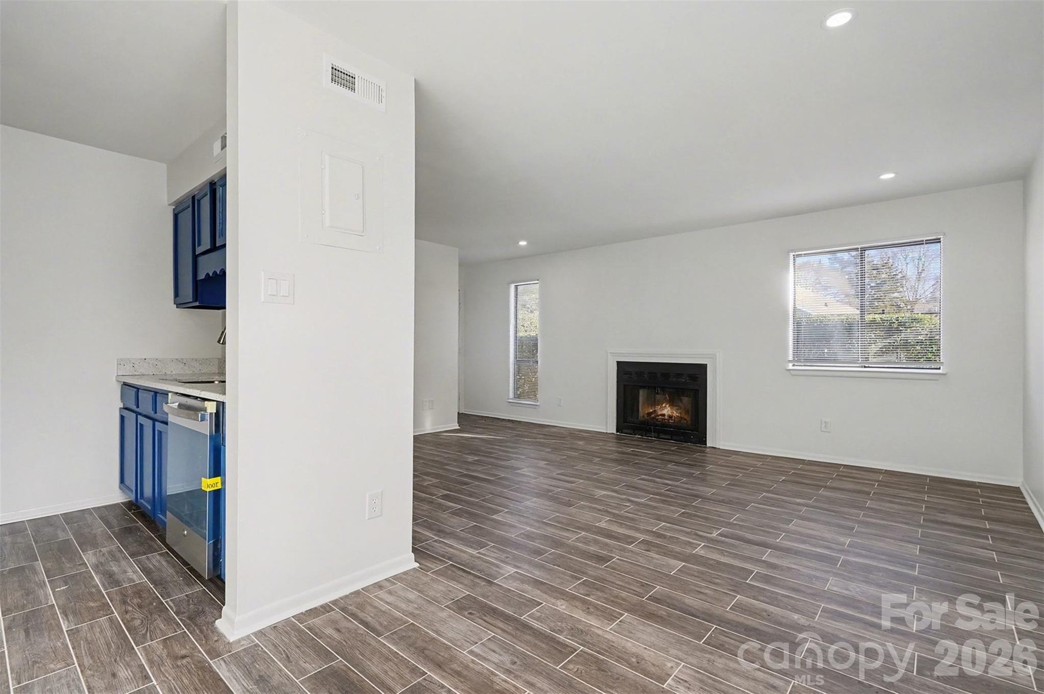 6148 Heath Ridge Court Charlotte, NC 28210 - Photo 10 of 27 a view of empty room with wooden floor and fireplace