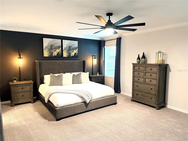 a spacious bedroom with a bed and a chandelier