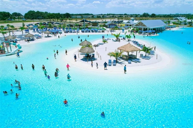 a view of a swimming pool with outdoor seating and mountain view