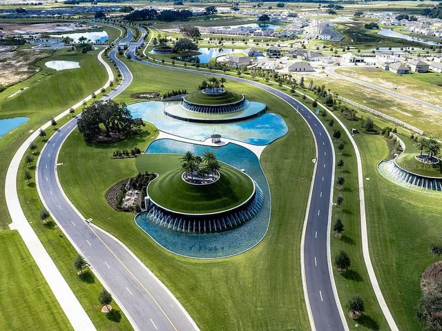 a view of a swimming pool with a dining table and chairs