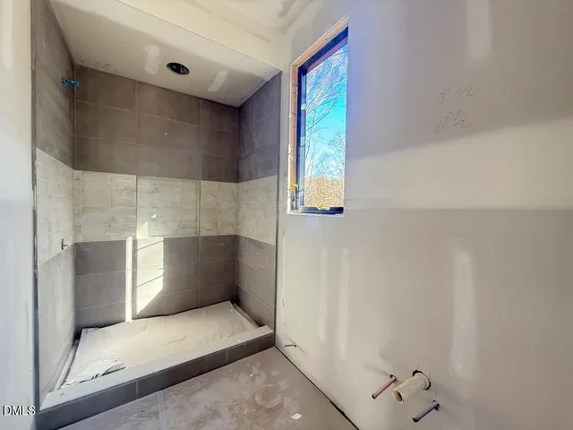 an empty room with a empty space and windows