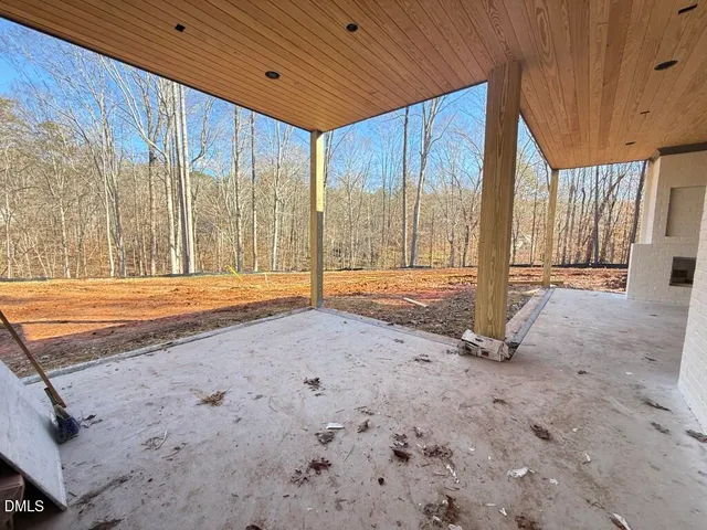a view of a hallway and a livingroom with furniture