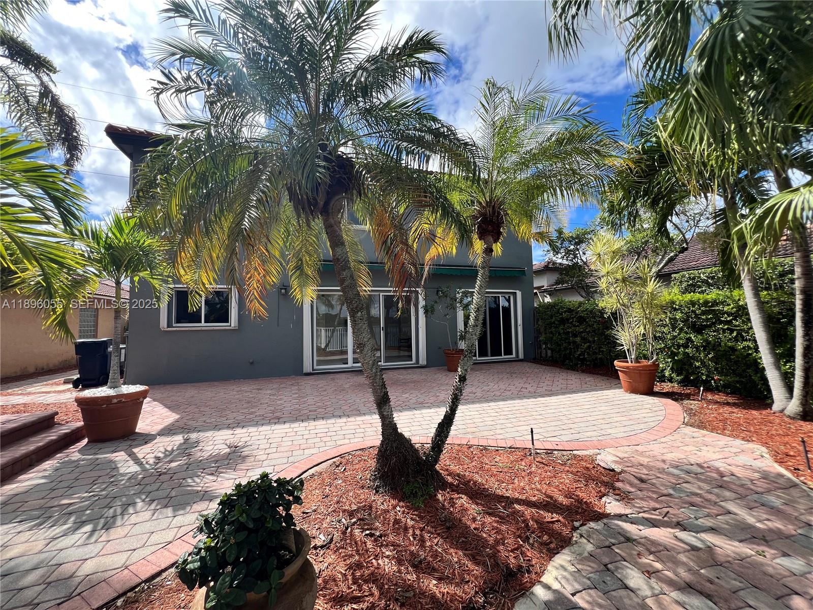 12247 Southwest 140th Street Miami, FL 33186 - Photo 16 of 86 a view of a backyard with palm trees