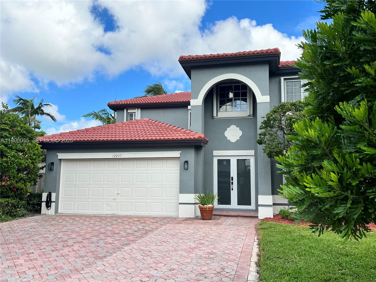 12247 Southwest 140th Street Miami, FL 33186 - Photo 3 of 86 a front view of a house with yard