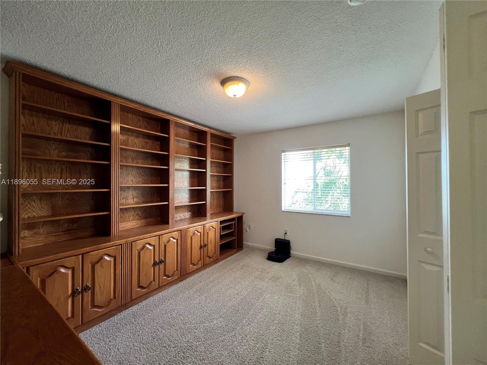 12247 Southwest 140th Street Miami, FL 33186 - Photo 50 of 86 a view of an empty room with shelves